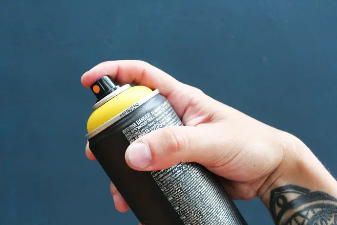 a person holding a black and yellow water bottle